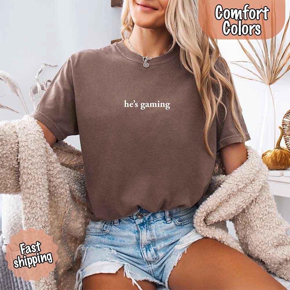 He’s Gaming – Funny Relationship Comfort Color Shirt for Her